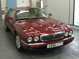 A burgundy Jaguar XJ finished in the workshop