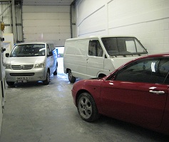 Cars and a van in the workshop