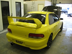 A yellow Subaru Impreza after a full respray