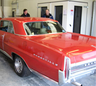 A red classic Pontiac in the workshop