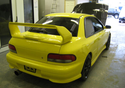 Subaru Impreza in yellow, rear view